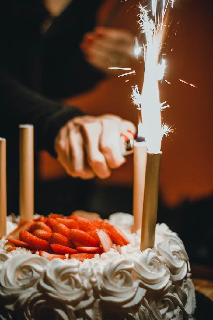 about-01 A captivating image of a birthday cake adorned with lit sparklers and fresh strawberries.